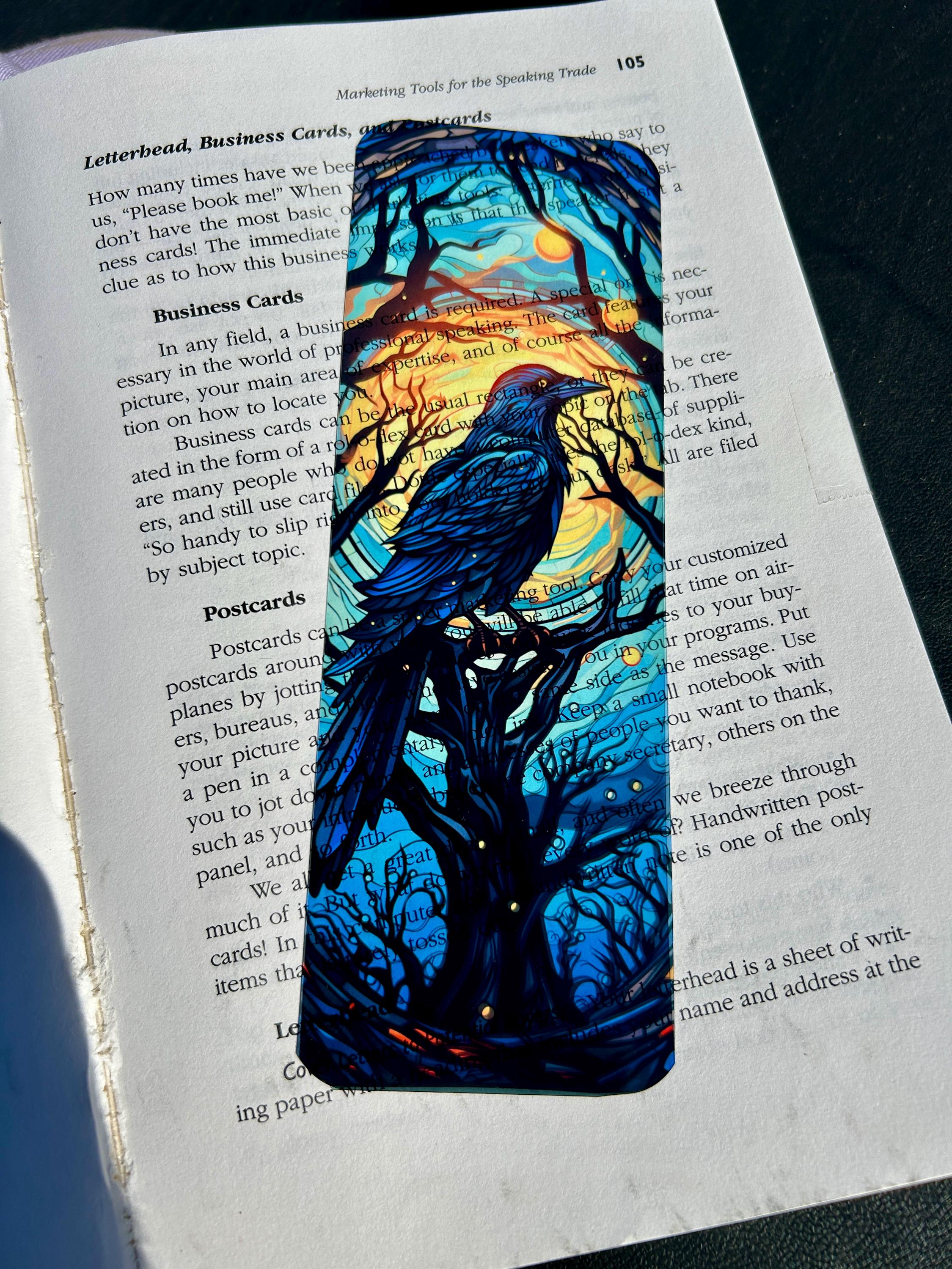 Gothic raven bookmark with stained glass arch, sunset skies and vintage pedestal, dark fantasy bird art for moody readers
