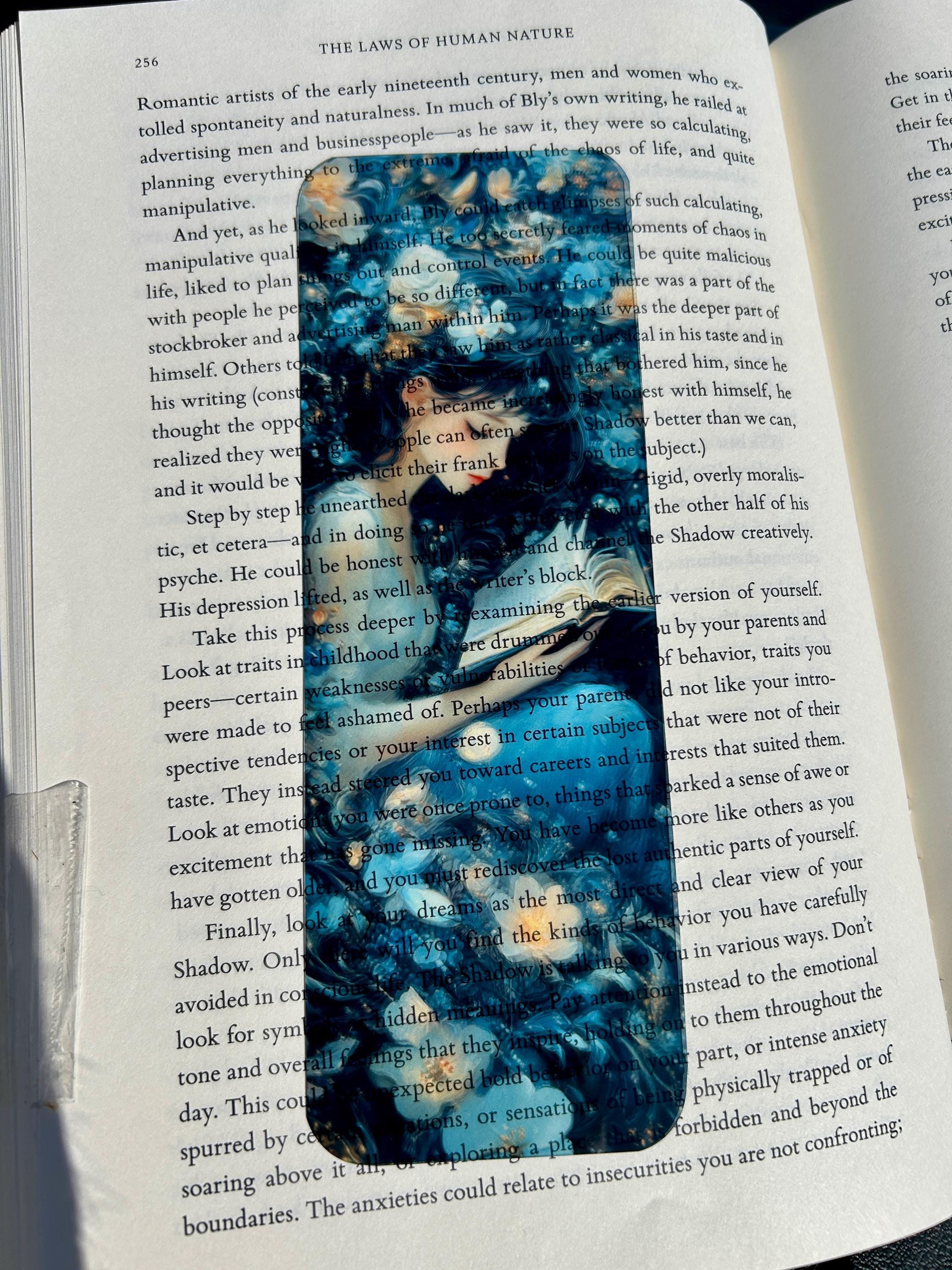 Magical twilight garden bookmark with girl reading among glowing flowers and dreamy blue petals