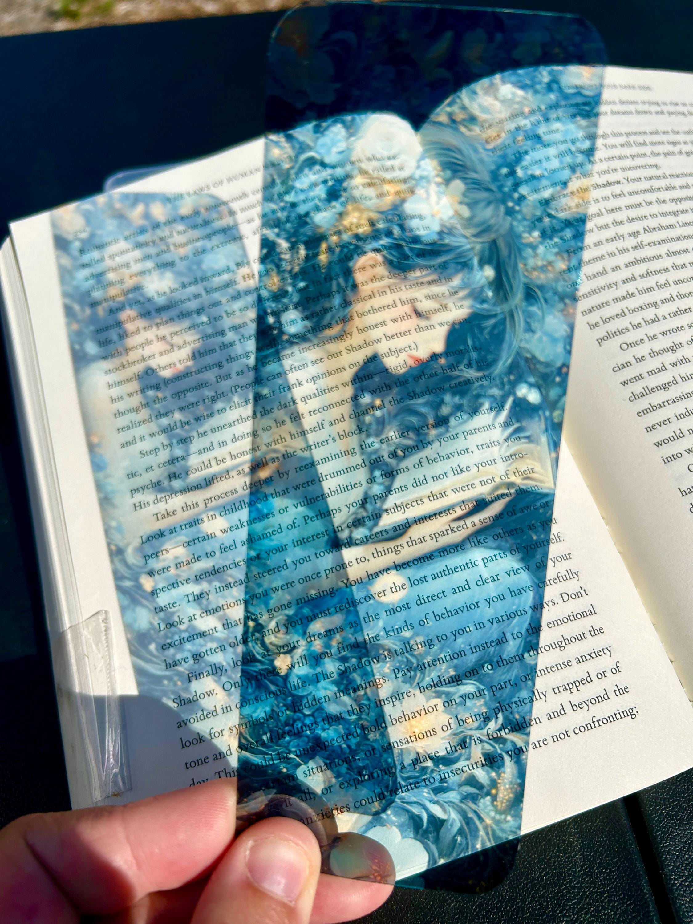 Magical twilight garden bookmark with girl reading among glowing flowers and dreamy blue petals
