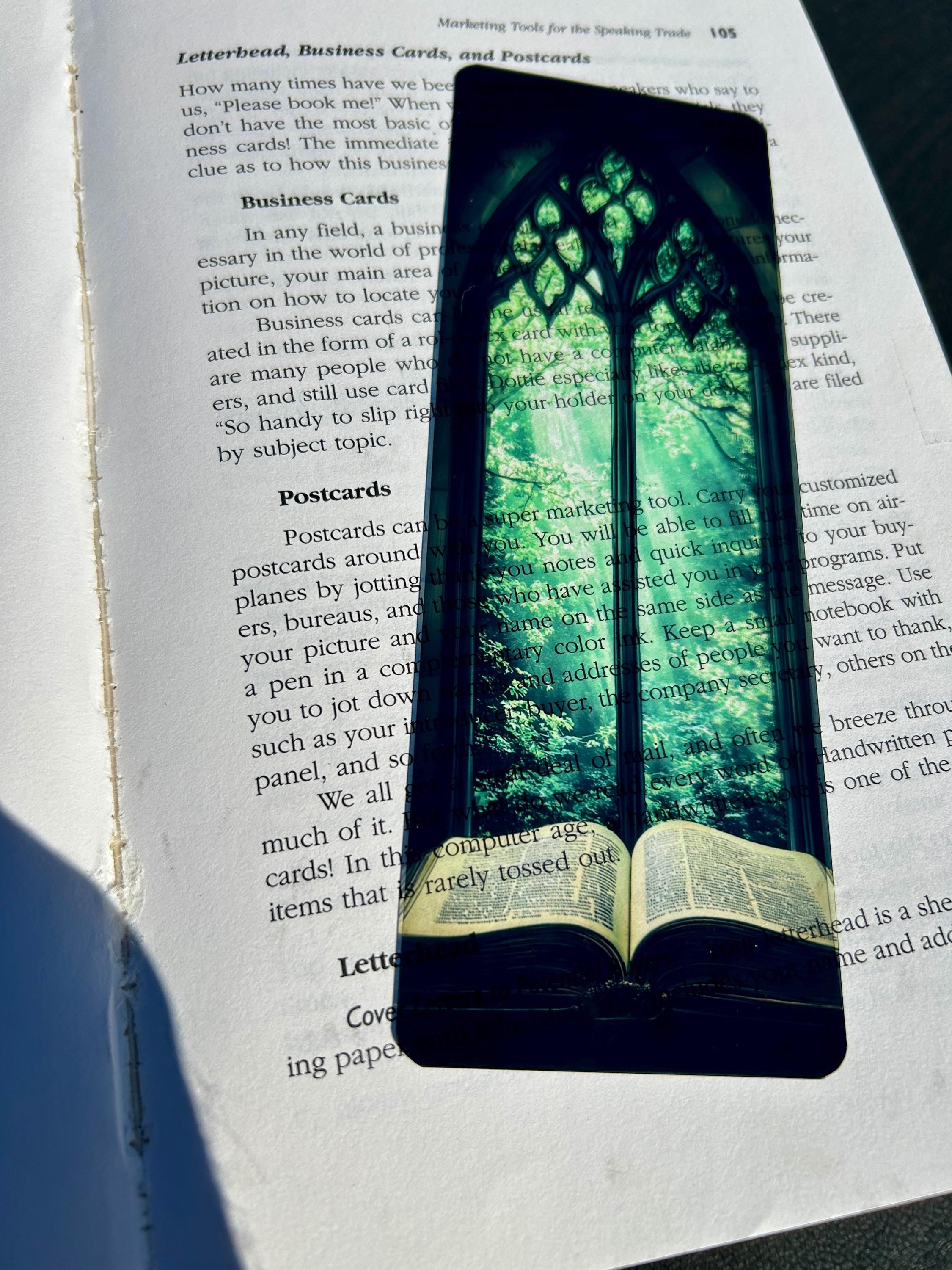 Bible Bookmark – Stained Glass Window Arch with Green Canopy & Glowing Light Over Ancient Open Book