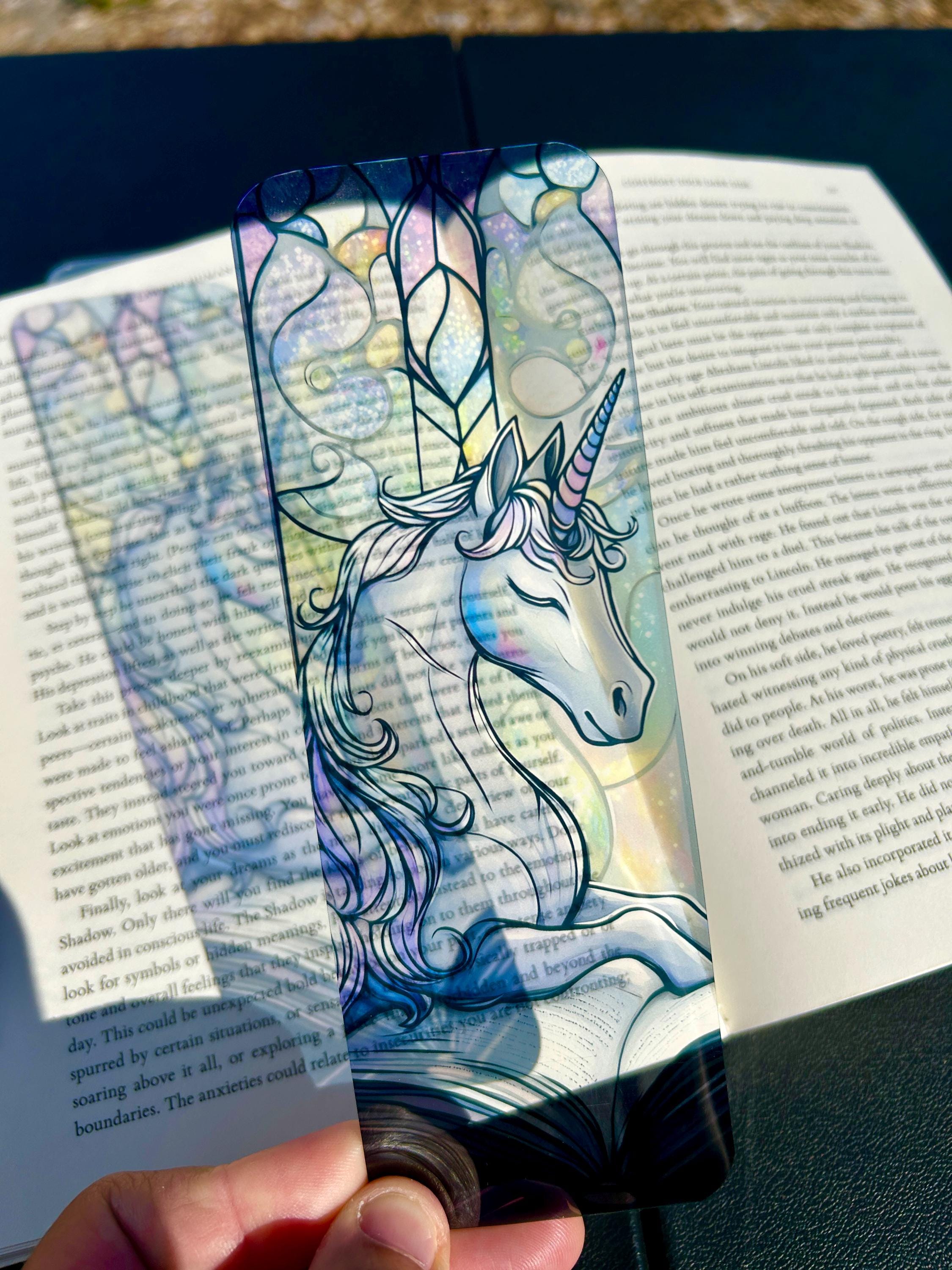 Stained glass unicorn bookmark dreamy lilac unicorn resting beside an open storybook